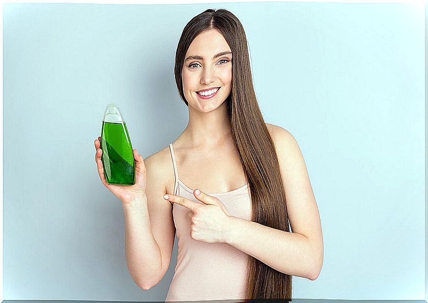 Woman holding a shampoo.