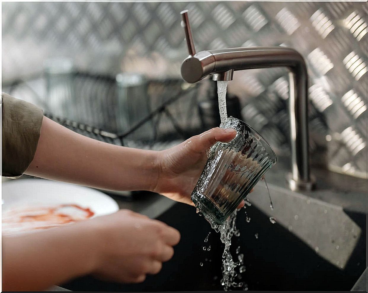 Wash dishes in the sink.