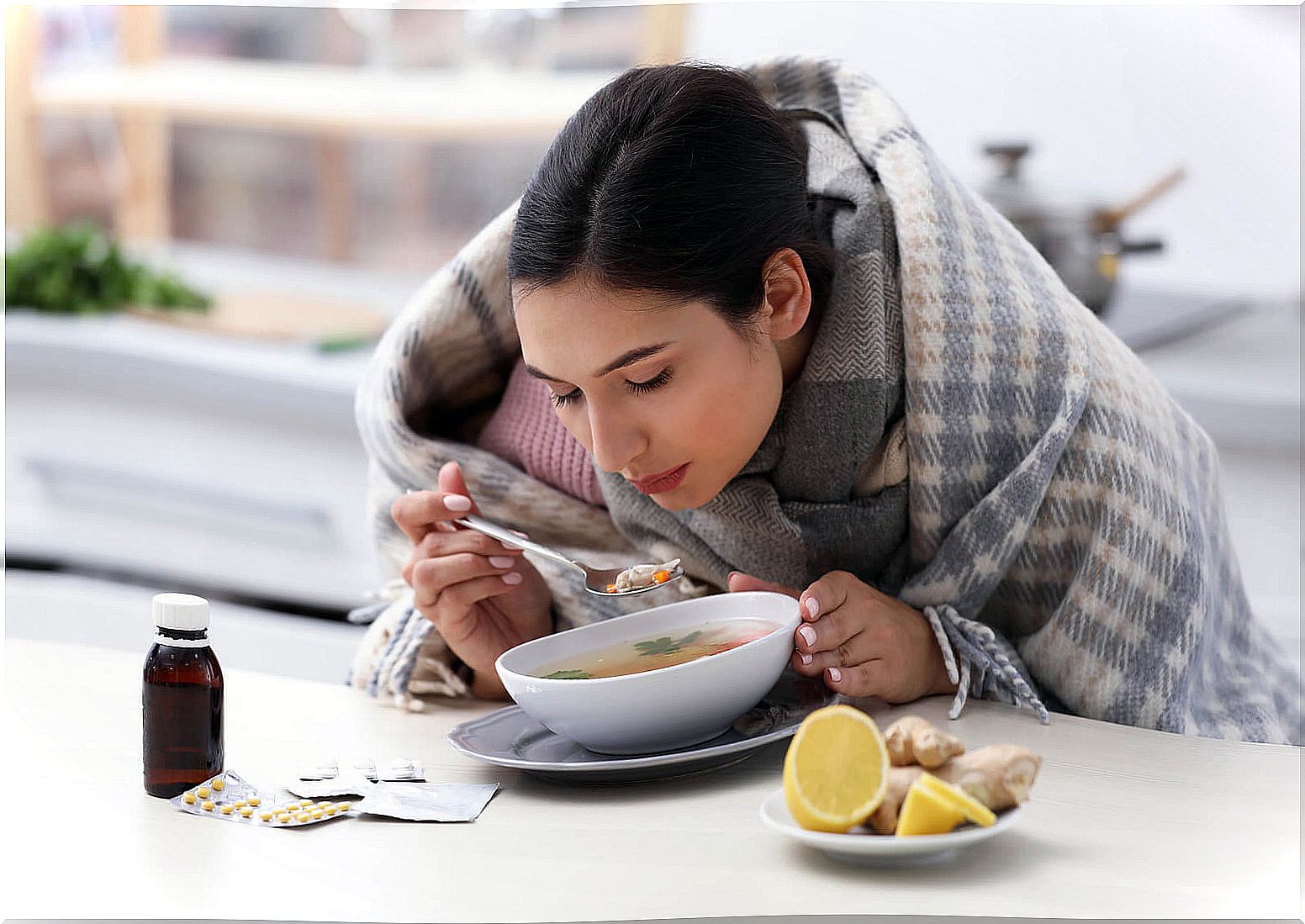 Woman with flu drinking soup.