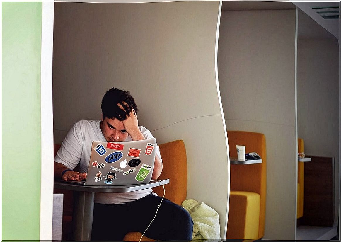 Boy with computer representing depression in college students.