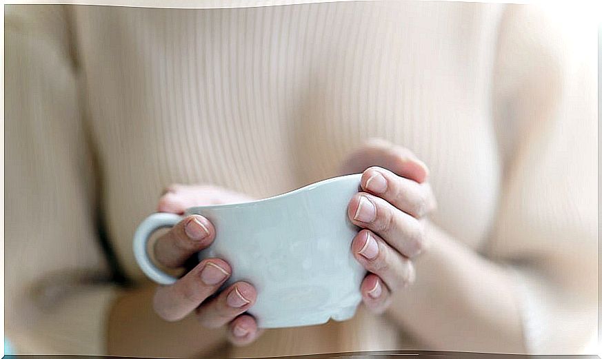 Woman holding cup of tea