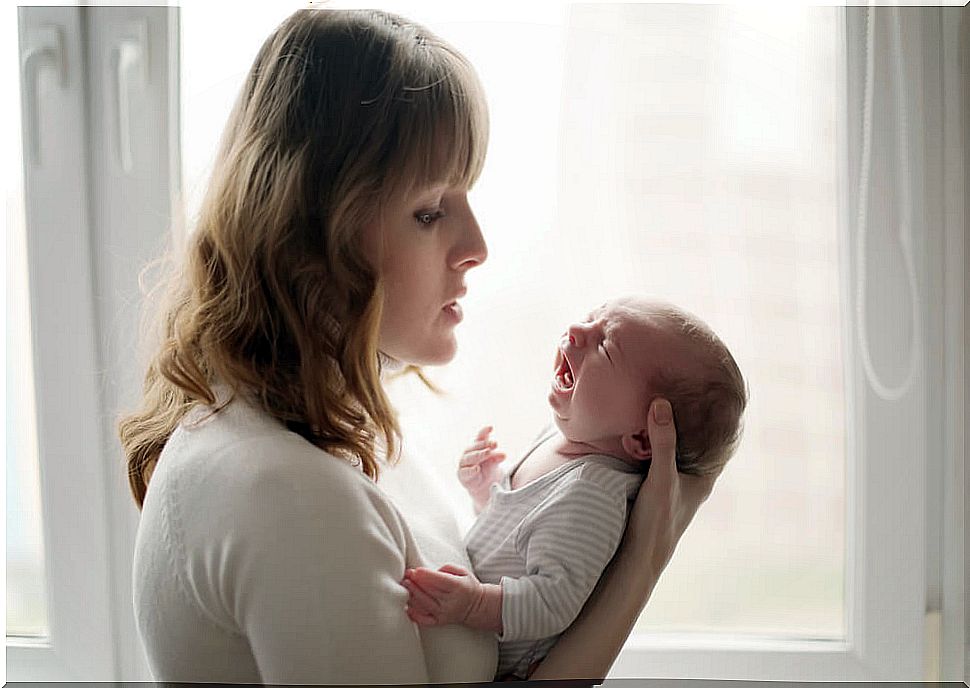 mother holding her crying baby