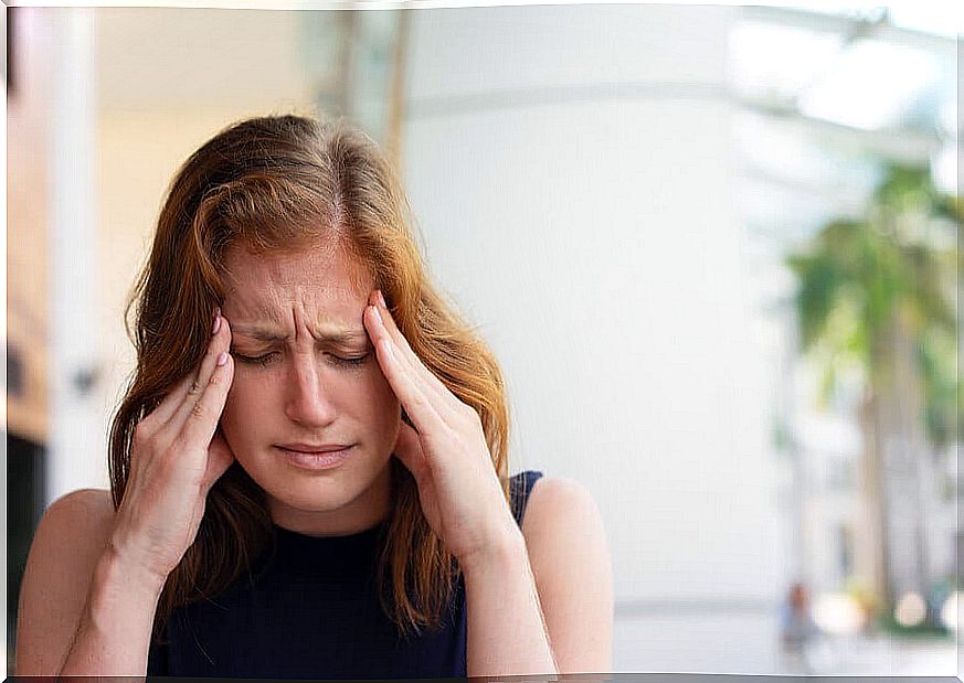 Woman with headache from anxiety.