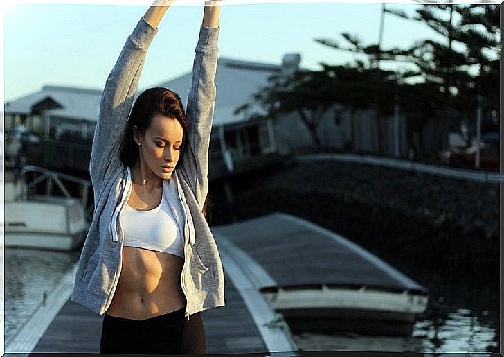 Woman in sportswear doing stretching outdoors.